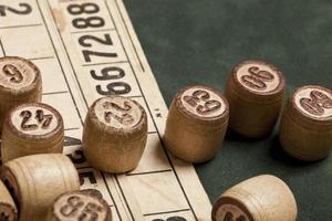 Table game Bingo. Wooden Lotto barrels with bag, playing cards for Lotto games, games for family. photo