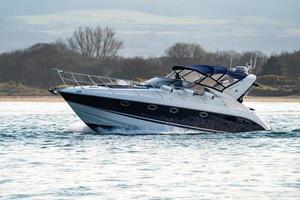 Speed boat at low tide heading out to sea photo