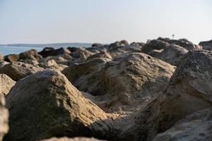 Sand blown over rock groynes photo