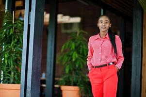 Pretty braids business african american lady bright bossy person friendly wear office red shirt and trousers. photo