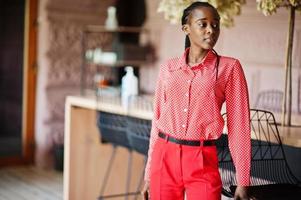 Pretty braids business african american lady bright bossy person friendly wear office red shirt and trousers. photo