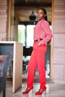 Pretty braids business african american lady bright bossy person friendly wear office red shirt and trousers. photo
