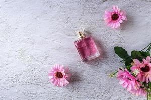 pink perfume bottle with pink flowers photo