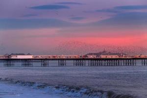 BRIGHTON, EAST SUSSEX, UK. Starlings over the Pier in Brighton East Sussex on January 26, 2018. Unidentified people photo