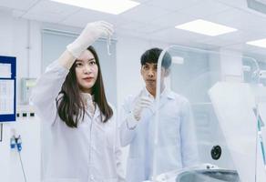 young female scientists open centrifuge in medical laboratory photo