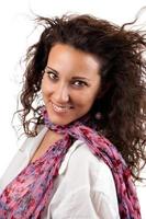Cheerful young woman smiling with pink scarf and white background. photo