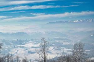 landscape of the Piedmontese Langhe completely covered by the white snows of the winter of 2022 in January photo