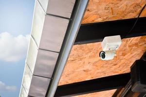 Mini cctv cameras installed on the wall outside the house to record and to do security at home when the house owner stayed outside, soft and selective focus on cctv cameras. photo