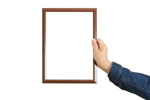 A blank diploma or a mockup certificate in the hand of a woman employee wearing a denim shirt on white background with a clipping path. The The vertical picture frame is empty and the copy space. photo