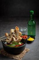 Korean fish cake and vegetable soup on table photo