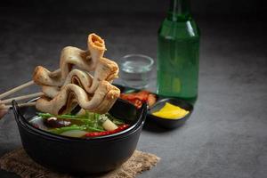 Korean fish cake and vegetable soup on table photo