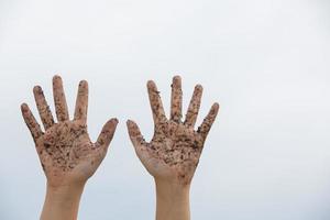 dusty girl's hand held up in the sky photo