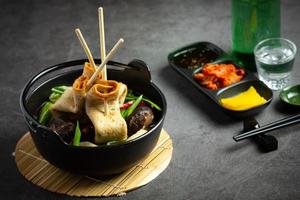 Korean fish cake and vegetable soup on table photo