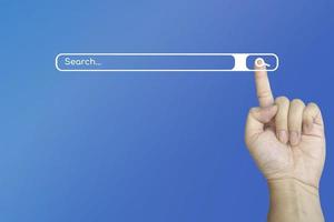 Hand with a finger touch on search symbol on the internet for searching the information data on blue background. photo