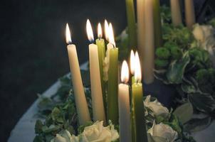 Lit votive prayer wax candles for church or home use photo