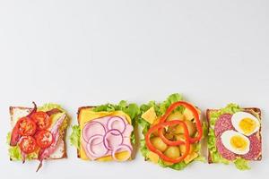 Different kind of sandwich on a white background, top view photo