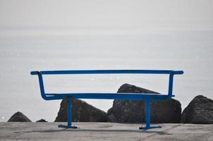 metal bench by the sea with copy space photo