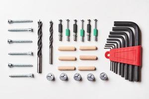 Tools for furniture assembly on a white background for mock up template design. View from above. Flat lay photo