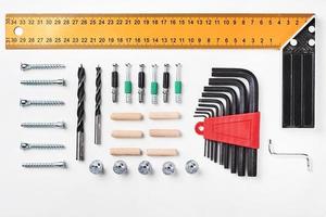 Tools for furniture assembly on a white background for mock up template design. View from above. Flat lay photo