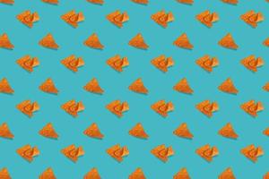 Nachos corn chips seamless pattern on blue background. photo