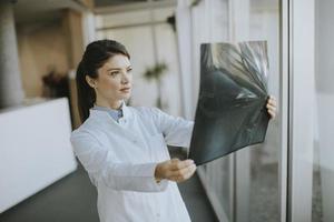 Young female doctos examining x-ray image in the office photo