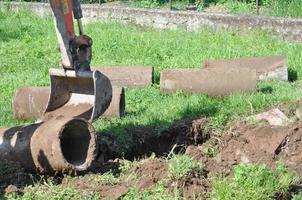 Excavator digging a hole photo