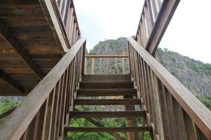 Wooden stairs with mountain and sky background. photo