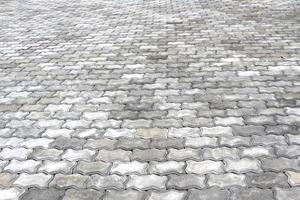 Perspective view of grey brick stone pavement.
