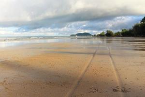 The traces of the wheels on the beach. photo