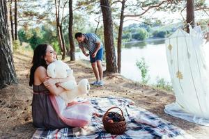 pregnant woman with her husband at  picnic photo