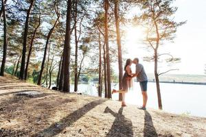 pareja romántica en la playa en el colorido fondo de la puesta de sol foto