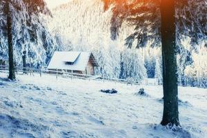 cabin in the mountains in winter photo