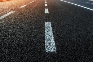 New asphalt texture with white dashed line photo