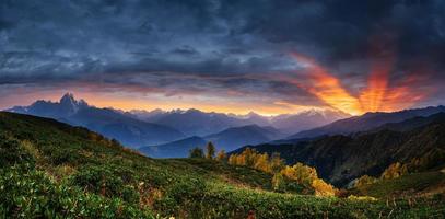 Sunset over snow-capped mountain peaks. photo