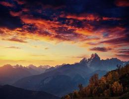Autumn landscape and snowy mountain peaks. Fantastic sunset. Vie photo