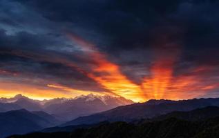 Sunset over snow-capped mountain peaks. photo