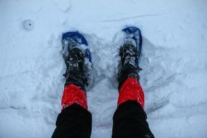 pies en raquetas de nieve en la nieve. foto