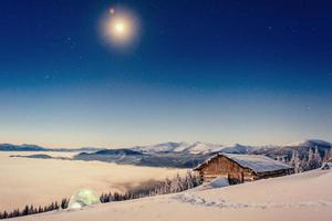 Footpath in winter mountains leading to the chalets photo