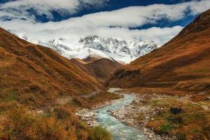 Snowy mountains and noisy mountain river photo