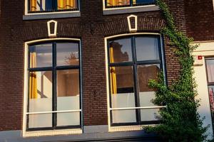 Brown wooden window in brick house. Europe photo