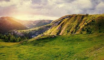 Fantastic sunset in the mountains during the summer season. photo