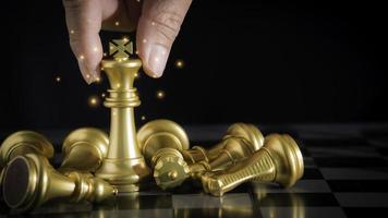 mano del hombre de negocios que sostiene el ajedrez rey dorado para luchar contra el ajedrez rey plateado para jugar con éxito en la competencia con antecedentes de red tecnológica. concepto de estrategia de gestión o liderazgo.
