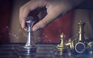 Hand of confident boy moving pawn chess to development in competition success play which new strategy plan, leader and teamwork, network learning tactics and analysis concept. photo