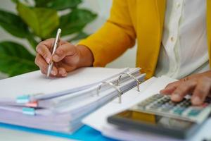 Businessman working and prepare paperwork report data to analysis information in file binder at office. photo