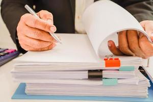 Businessman working and prepare paperwork report data to analysis information in file binder at office. photo