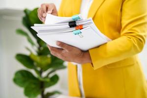 Businessman working and prepare paperwork report data to analysis information in file binder at office. photo