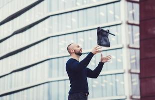 man throws a bag up photo