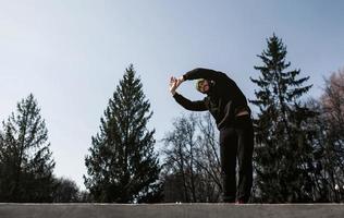 man in sports uniform warming up photo