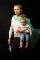 father in a medical mask holds his little daughter. The concept of protecting children during the epidemic of coronavirus photo