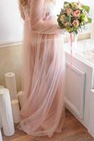 Morning of a beautiful young bride in a boudoir dress. photo